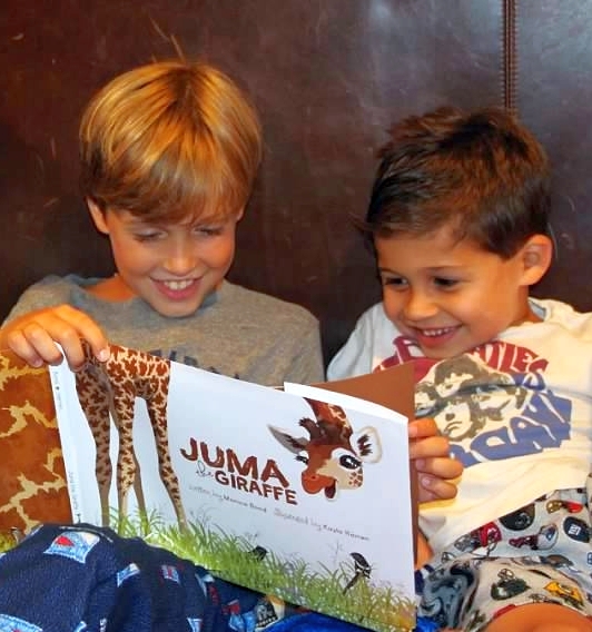 Picture of Two happy kids enjoying Juma the Giraffe. Wild Nature instiute